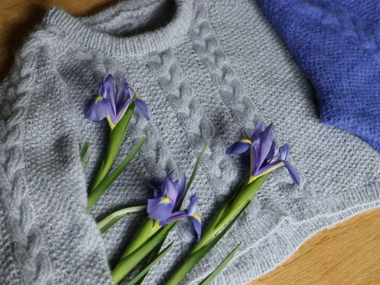 The Solstice Saddle styled flat on a table with flowers